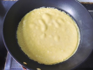 牛奶鸡蛋玉米饼,将面糊用勺舀入锅中，转动锅，成为一个圆饼，全程用最小火。