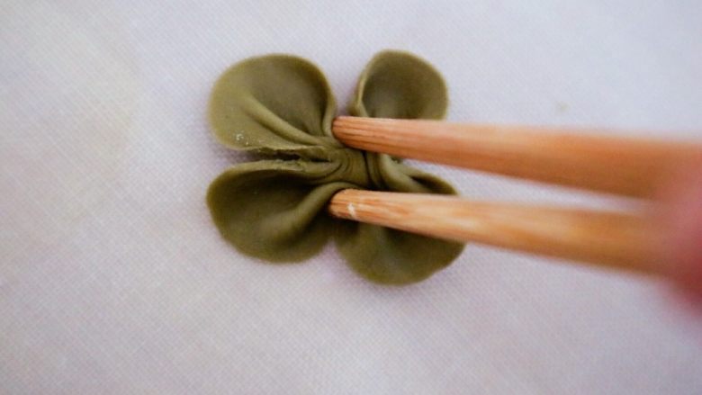 “山竹”馒头咬开有惊喜,在用筷子左右夹下，如图