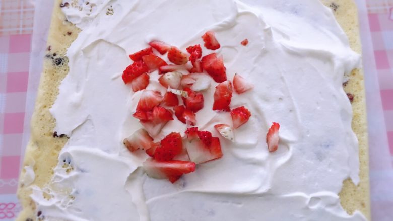 蔓越莓草莓奶油蛋糕卷,出炉后稍微冷却然后倒扣到新的吸油纸上，掀开底部的油纸，抹上打发好的奶油和切好的<a style='color:red;display:inline-block;' href='/shicai/ 592'>草莓</a>粒。