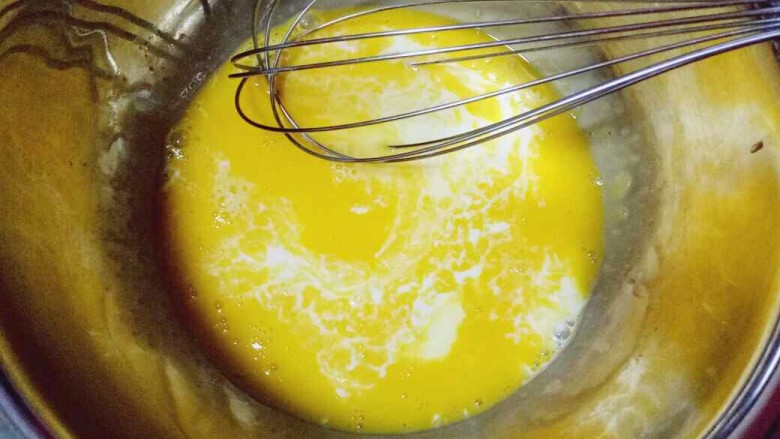 蔓越莓戚风蛋糕,先做蛋黄糊，蛋黄用手动打蛋器打散，加入牛奶继续打均匀至看不到牛奶。