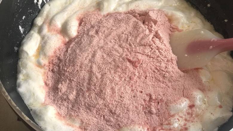 草莓牛轧糖,棉花糖融化后，加入奶粉和草莓粉