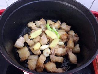 红烧肉炖土豆,放入葱姜蒜爆香