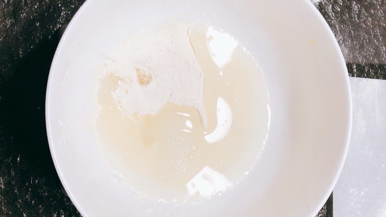 简单好用的糖霜配方,把温水倒入盛有蛋白粉的碗中（如果没有蛋白粉可以用蛋清进行替换水与蛋白粉的混合物，替换的蛋清约为40g）