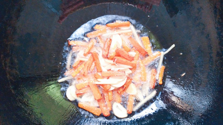 铁板鸡脆骨,把胡萝卜，蒜片，姜丝一起放下去翻炒几下！