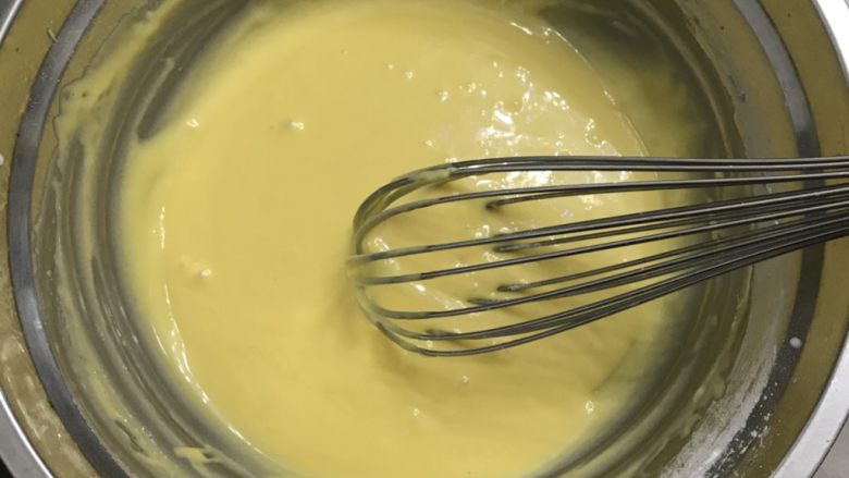 蜂蜜戚风纸杯蛋糕,用手动打蛋器把蛋黄搅拌均匀备用。