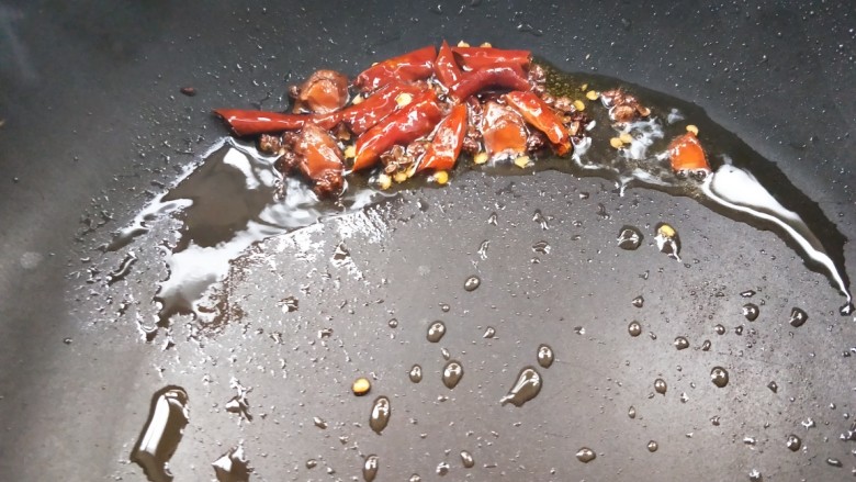 美味家常熬炒鸡,起油锅，放辣椒干，红椒，八角小火煸炒。