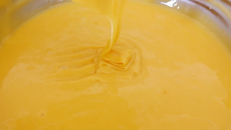 零失败的橙香蛋卷,用蛋抽搅拌成无干粉状态，如果面糊过干，加入适量的蛋液，反之加入糯米粉，同时预热蛋卷机