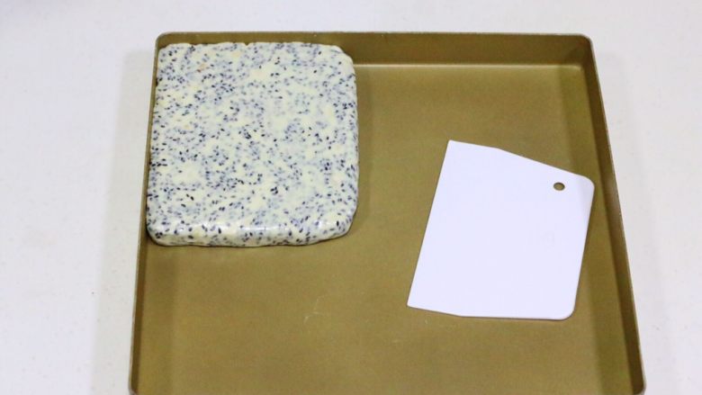 花生芝麻牛轧糖,如果没有不粘盘，可以直接放在油纸上整形的，有擀面杖的话可以直接擀平，边角可以借用刮板整平。