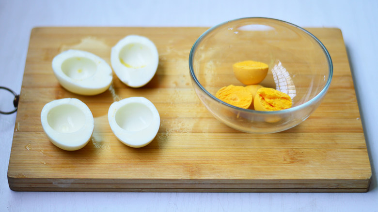 鸡蛋杯沙拉,将鸡蛋剥去壳对切，取出蛋黄