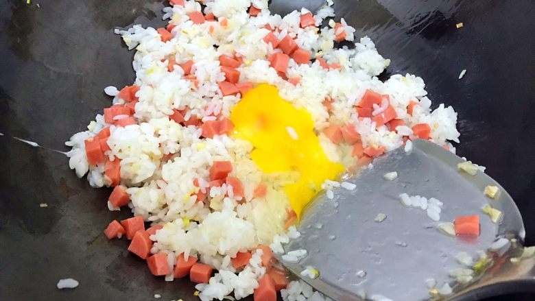 剩米饭and剩馒头也有春天🌿（蒜香火腿肠馒丁炒饭）,用锅铲将鸡蛋铺开来