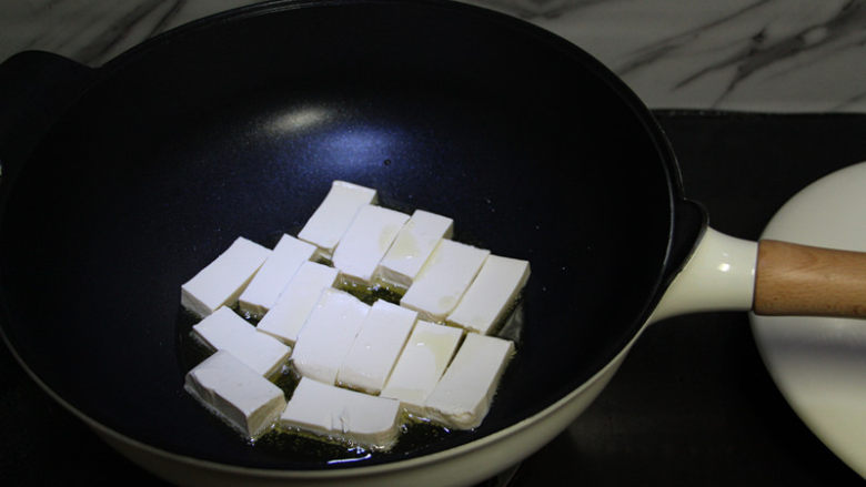 鸡蛋煎豆腐,油锅烧热，最好用不粘锅，这道菜就非常容易操作，铁锅容易粘锅，因为这豆腐太嫩了。