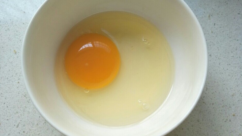 香脆可口～花生仁版桃酥,一个鸡蛋打入碗中。