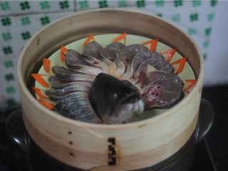 春节宴客菜—清蒸鲈鱼,将处理好的鲈鱼放在蒸笼上