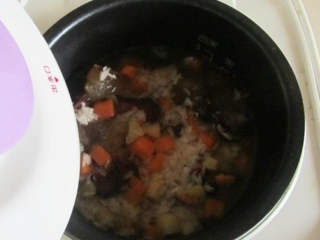 土豆腊肉焖饭,翻炒均匀后，所有食材移入电饭煲内，加水（和平时煮饭的量一样），开始煮。