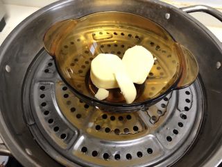 熬糖版花生牛轧糖,这时候另外准备一口锅放水烧开，黄油放碗里坐热水里融化成液体。