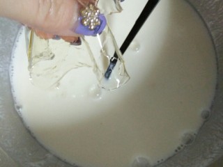 草莓牛奶羊羹,接着把酸奶加入牛奶中，搅拌均匀。然后加入泡软的吉利丁片，继续搅拌均匀。（吉利丁片要在牛奶溶液温热的时候放进去，这样才不会影响它的功效，牛奶溶液超过60度会影响它的功效，但如果冷了，就会溶解不了吉利丁）