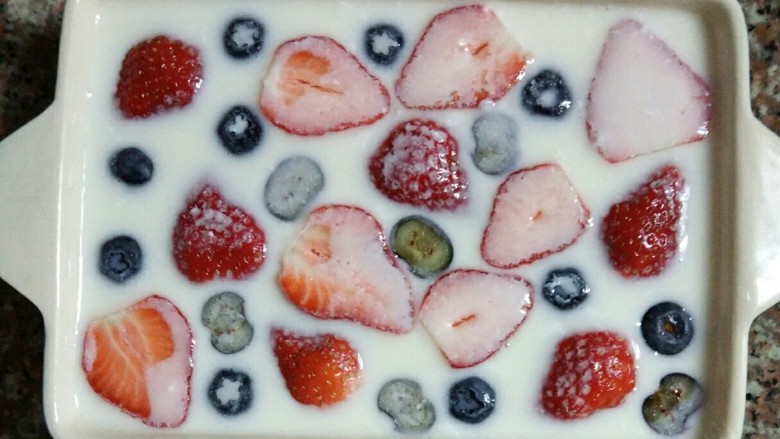 草莓牛奶羊羹,把牛奶溶液倒入容器中，放入洗净切好的草莓，和其他水果。水果会浮在表面。然后放入冰箱，冷藏四小时以上。
