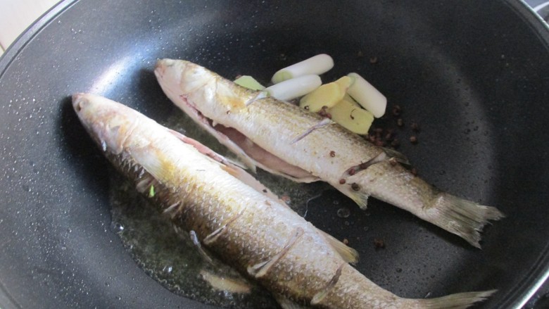 红烧梭鱼,放入葱姜，花椒一起炒香。