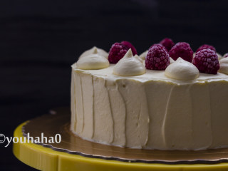 百香果旋涡蛋糕,取出定型后的蛋糕，将余下的淡奶油均匀的涂抹在蛋糕表面，无需涂抹光滑，蛋糕表面挤上奶油，放冷冻的树莓做装饰