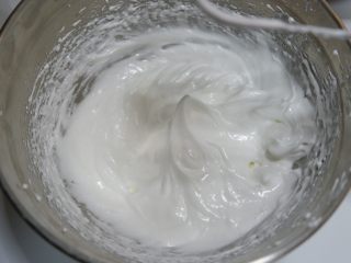 可可戚风纸杯蛋糕（适合裱花的蛋糕）,分3次加入细砂糖，用电动打蛋器打发蛋白，打至蛋白完全硬挺的干性发泡阶段。像图中这样能拉起挺立的小尖角。