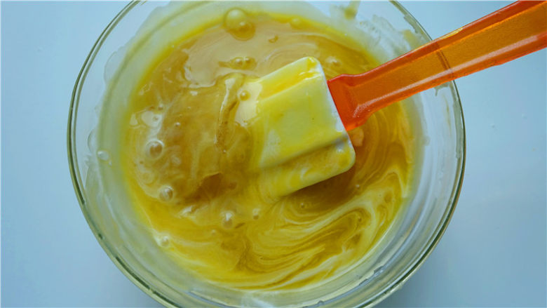 芒果淋面慕斯蛋糕,加入冰水泡软的吉利丁片（沥干水分）。最后全部倒入步骤2的融化巧克力中，轻轻拌匀，如果喜欢更佳的颜色，可以滴入柠檬黄食用色素。自然冷却至室温状态，可用。