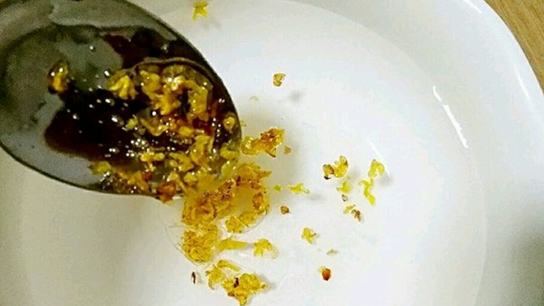 桂花黑芝麻汤圆（纯手工无油低糖版）,碗中加适量凉开水，在凉开水中加入桂花蜂蜜（蜂蜜一定不要用热水冲哦）冲开。