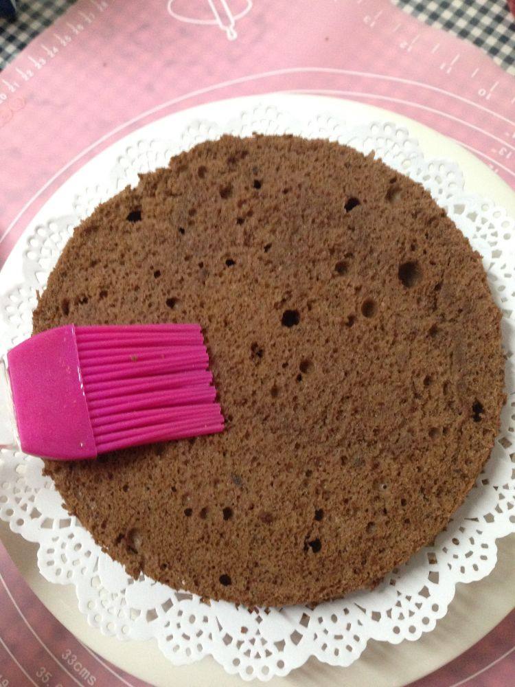 情人节――给爱人的礼物黑森林蛋糕,取一片蛋糕放入模具，在表面刷满樱桃酒糖液，并使其充分渗透