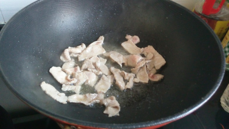 鸡腿菇炒肉,锅中放油，三成热下入腌好的瘦肉，变色盛出备用