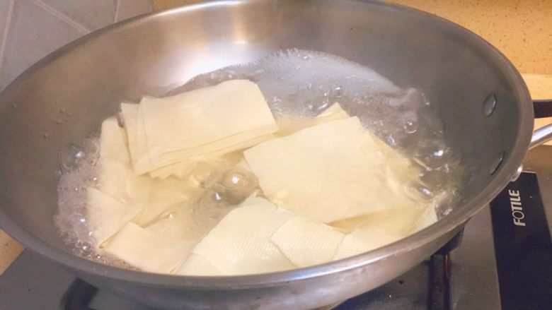 东北那旮沓的美食★京酱肉丝,这时候，水差不多开了。我们把干豆腐皮放进去烫煮2分钟。然后捞出来，沥干水分，备用。