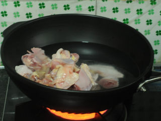 三杯鸡,将土鸡块倒入凉水锅里汆烫