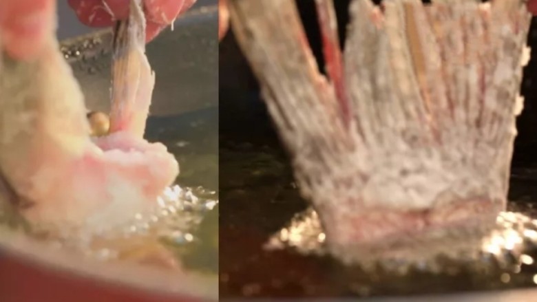 红茄松鼠脆鱼,捏住鱼下巴两端的鱼鳍，炸鱼下巴，当定型后，放入锅中继续油炸，待全熟后捞出。
然后用同样的方法炸鱼尾。