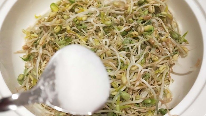 绿色食品\在家就能涨豆芽\香辣凉拌绿豆芽,趁热放入适量盐。