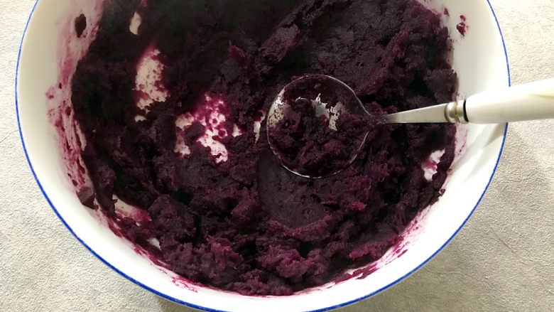年夜饭の紫气东来～蔓越莓芝心紫薯球,用勺子搅拌均匀并且压烂紫薯成泥