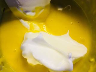 新春“福气”奶油卷,取三分之一蛋白加入蛋黄糊中。翻拌均匀