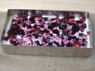 蓝莓芝士慕斯蛋糕,凝固好的慕斯上铺一层蓝莓果酱（保留少许果汁，最后做装饰用）