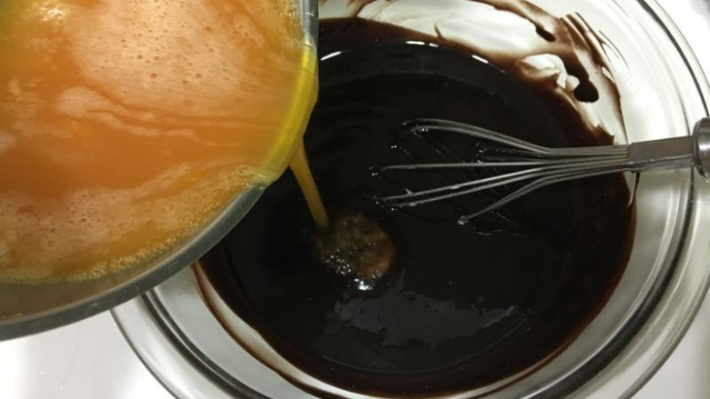 巧克力熔岩蛋糕,蛋液慢慢加入巧克力糊搅拌均匀。
