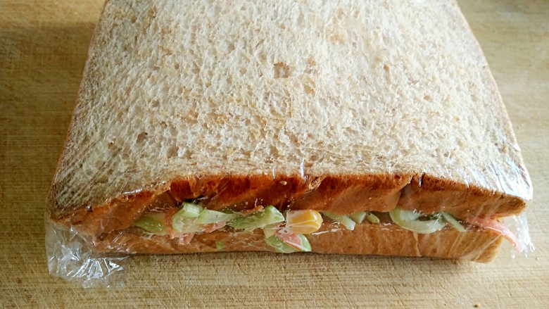 沼三明治,用保鲜膜裹紧。