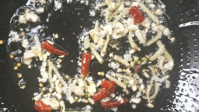 辣出天际的辣炒腊鸭肠,起油锅，倒入蒜末和姜丝，干辣椒掰断放入。