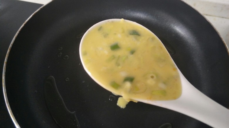 葱花鸡蛋饼,平底锅加入倒少许油，用勺子把挖一勺放锅中。