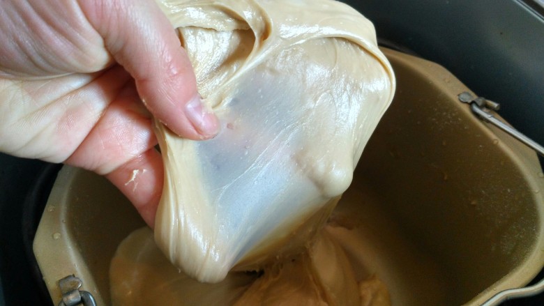 花样土司+咖啡椰蓉土司,继续揉面至面团完全阶段，可拉出半透明的手膜，且破洞边缘光滑，约15分钟。
开启发酵功能，揉好的面团留在面包里发酵，约50分钟