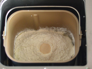 肠仔包,除黄油外的材料先放入面包桶，揉至无干粉状态