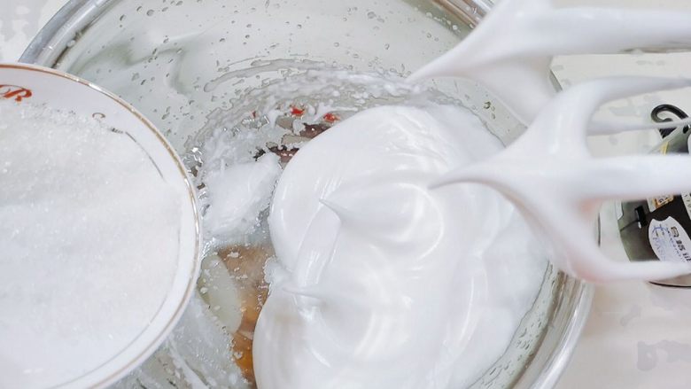 普通面粉版-原味戚风蛋糕卷,打发至有尖角并出现纹路的时候，加入剩下的糖，降为低速打发。直至提起打蛋器，尖角不消失为止。
