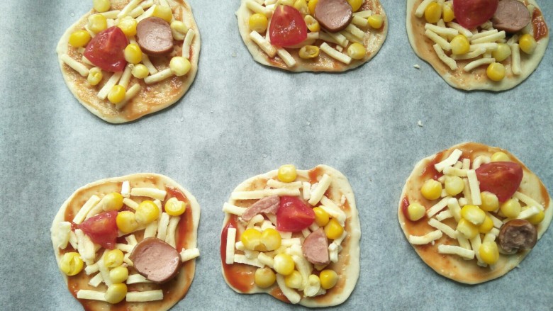 香烤迷你小披萨,放入切碎的圣女果，香肠，玉米，马苏里拉芝士。