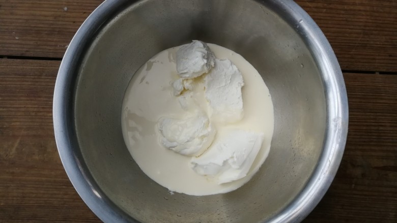 轻乳酪蛋糕,<a style='color:red;display:inline-block;' href='/shicai/ 48598'>奶油奶酪</a>、淡奶油和牛奶一起倒入盆中，隔热水用手动打蛋器搅拌均匀