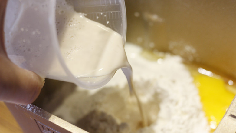 原味基础吐司（面包机版）,在面粉中挖一个面坑，将酵母粉倒入。准备就绪后放入面包机，开启和面模式。