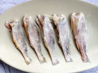 小杂鱼一锅出,将鱼的两面沾上少许的面粉。