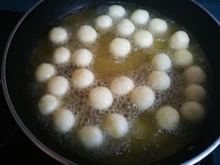 椒盐小土豆球,锅里油烧热后放入土豆球，炸至金黄时捞出控油。