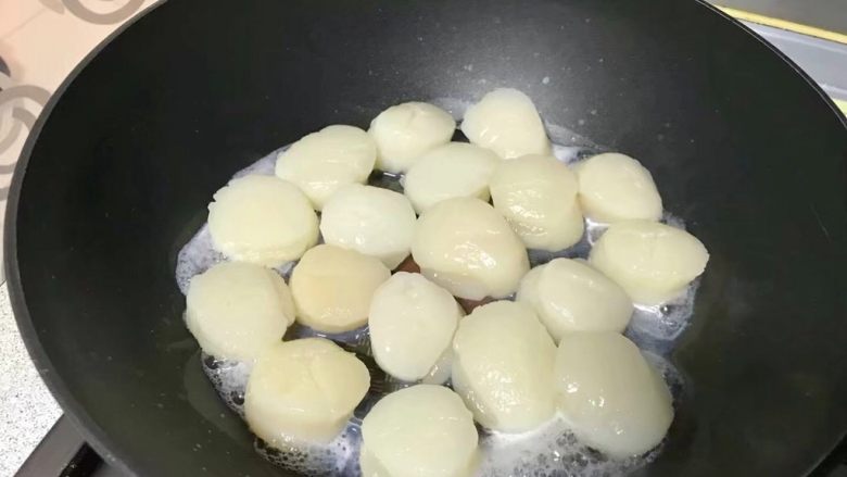 鲜贝滑蛋,把解冻好的鲜贝排在锅里，煎。