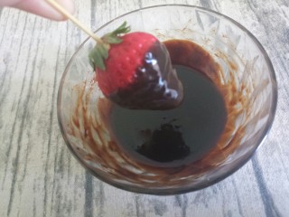 草莓巧克力,如图，四圈都沾上巧克力液，底部可以留一点草莓出来，这样比较好看