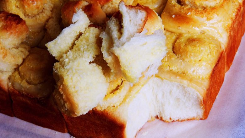椰蓉花色面包卷,切开后再看看，椰蓉香味浓，面包可以一层层剥开，撕开后还可以看到拉丝。